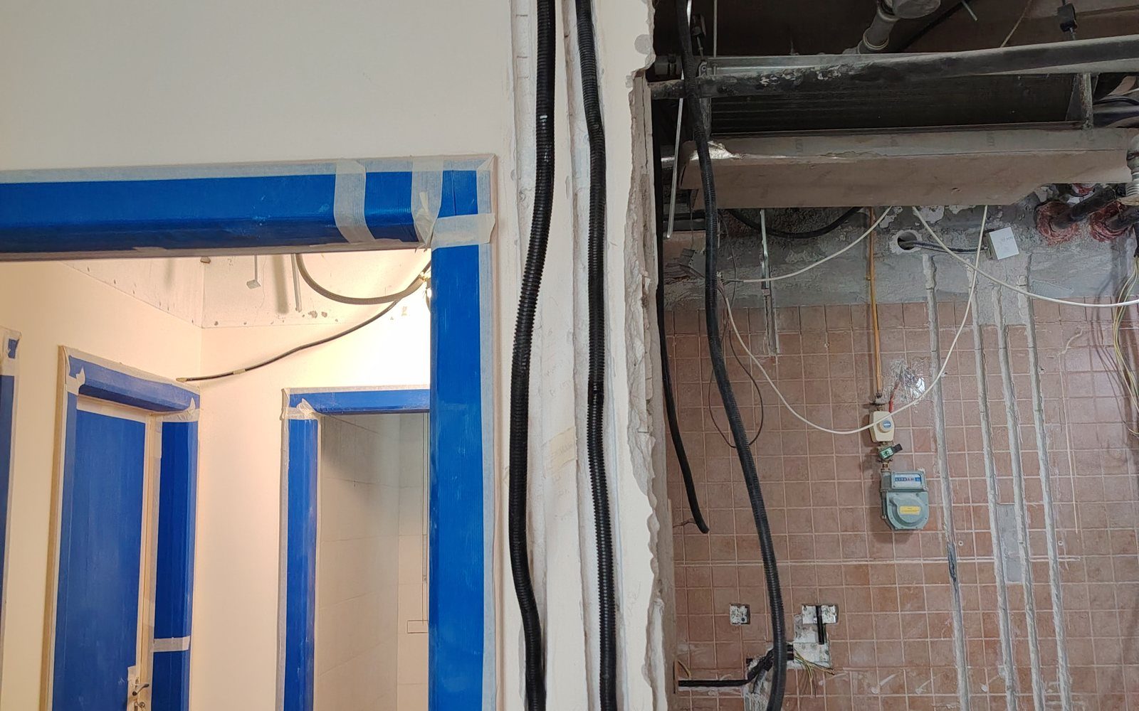 Routing of power cables in conduits along the walls and preparation of doorways