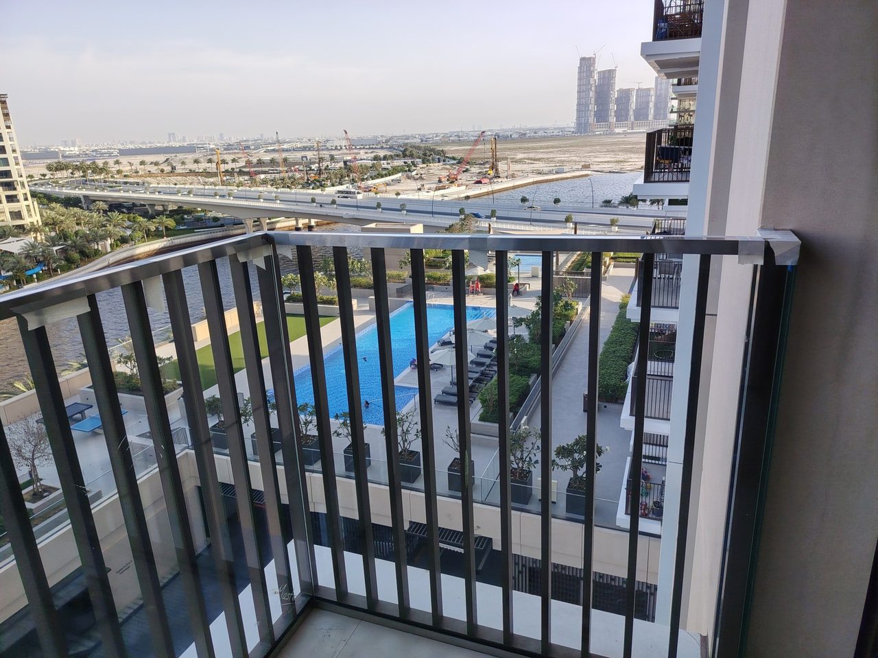 Installed protective glazing behind the metal balcony railing