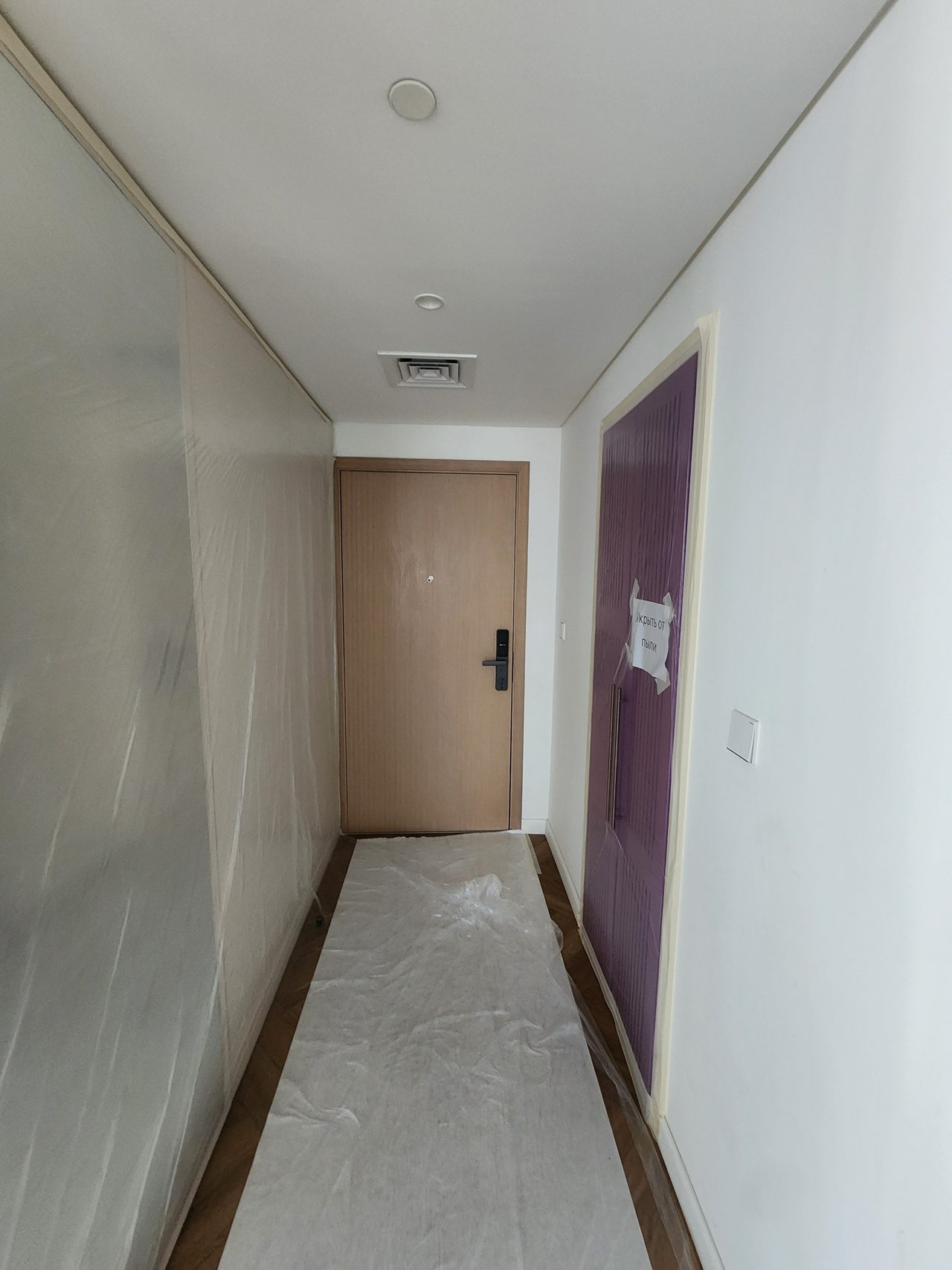 Protection of the entrance area: the floor is covered with heavy-duty material, and walls and doors are shielded with film against dust and accidental damage