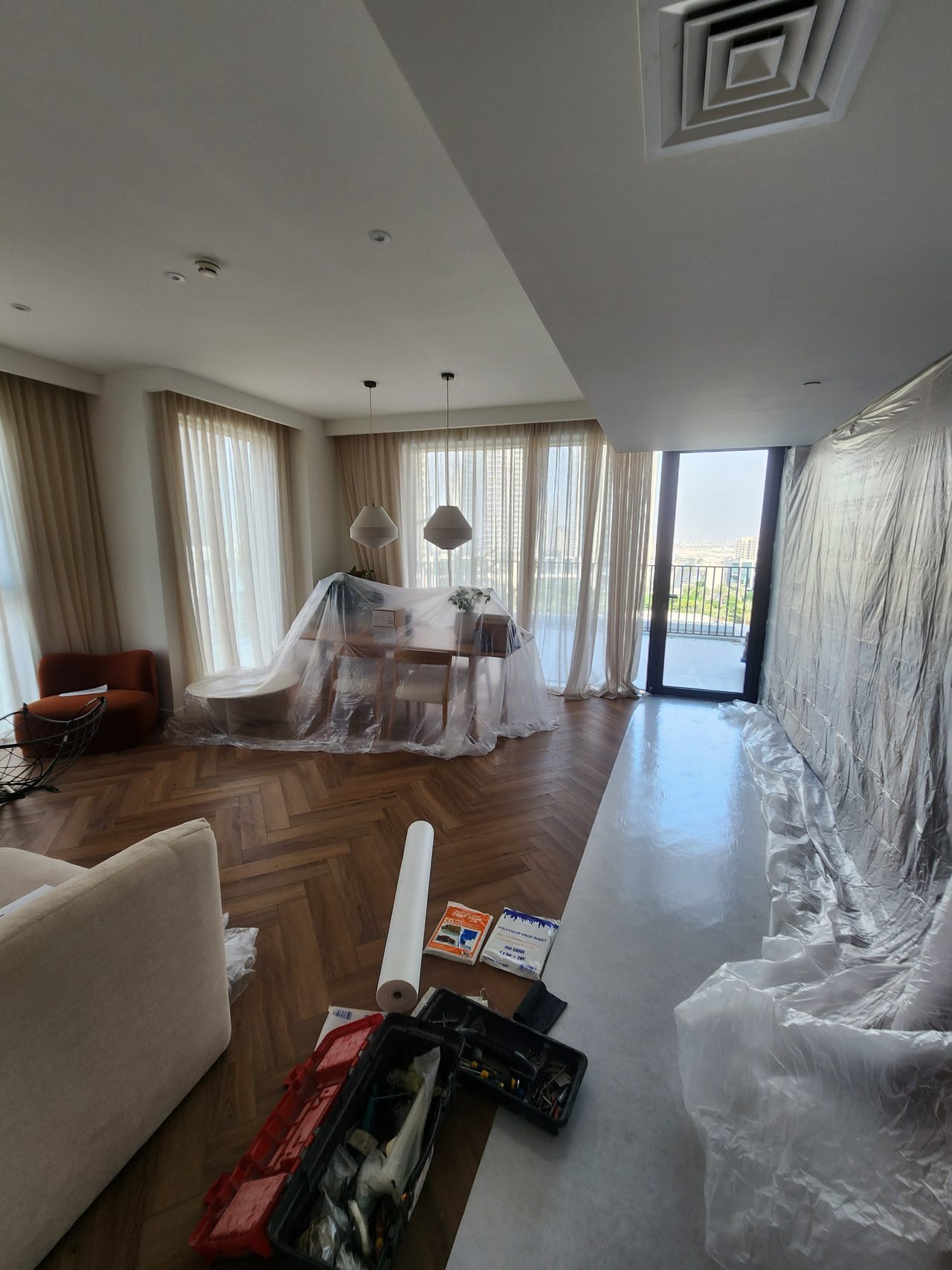 Ensuring the safety of final finishes and furniture in the living room using protective covers and films